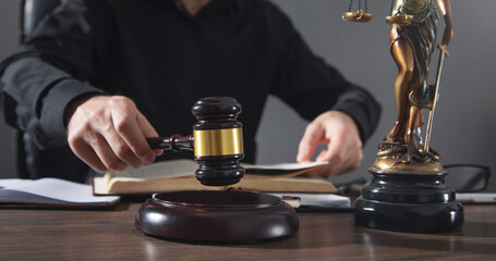 Male judge in a courtroom striking the gavel.