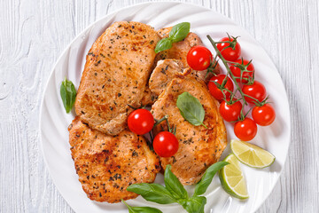 tomato basil pesto fried pork cutlets on plate