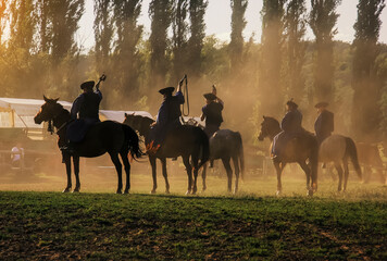 Hungarian horseman ride five horses. He wears the traditional Hungarian national costume for the...