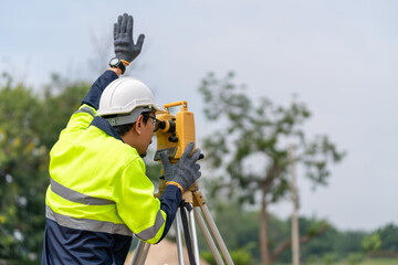 Asian Surveyor Civil Engineer working theodolite or total positioning station on the construction...