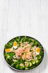 pink cocktail shrimps salad with veggies and eggs