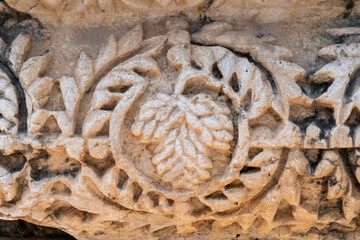 Close up of dates carving at the ruins of Capernaum in Israel other names Kfar Nahum or Capharnaum.
