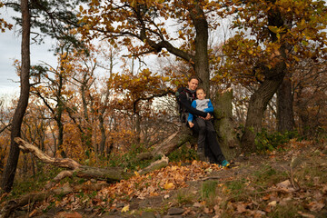 Mum and child are walking along the mountain hiking trail. Family spending time.