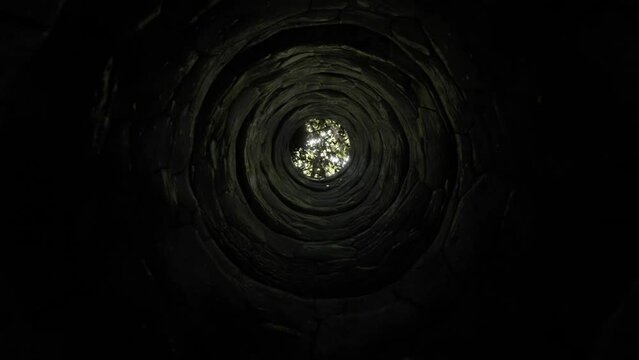 3d illustration. Climbing from the depths of the old well to the top.