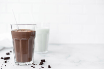 a glass of chocolate milkshake with a straw, copy space