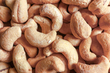 Top view macro shot of group roasted cashew nuts background. Healthy foods or diet concept.