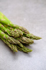 Green asparagus on a gray bockground. Seasonal fresh food