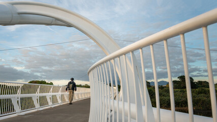 Man walking on Te Rewa Rewa bridge which is under maintenance, New Plymouth