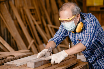professional carpenter wooden furniture maker handcraft working in wood workshop with safety