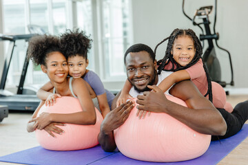 healthy black family children and parent exercise activity healthcare together at fitness sport...