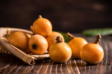ripe loquat fruit on wooden table