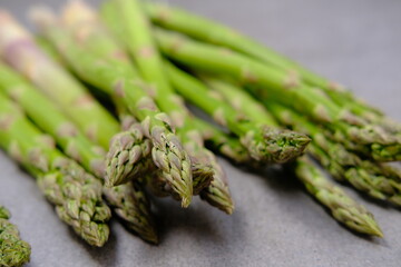 Green asparagus on a gray bockground. Seasonal fresh food
