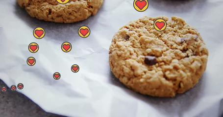 Rolgordijnen Image of hearts floating over cookies on cooking paper © vectorfusionart