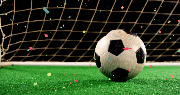 Image of confetti over soccer ball at stadium