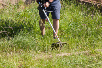 gardener cutting the weeds, preparation of the field.