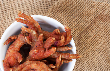 South African township delicacy,  fried chicken feet or walkie talkies with onion and sauce