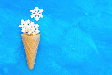 Waffle cone with snowflakes on blue