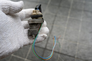 Mechanic holding a Speed Sensor for car.