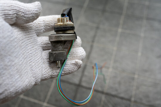 Mechanic holding a Speed Sensor for car.