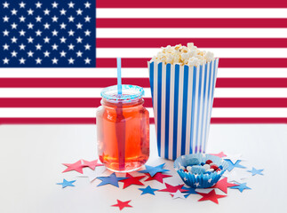 independence day, patriotism and holidays concept - close up of popcorn, juice in mason jar glass...