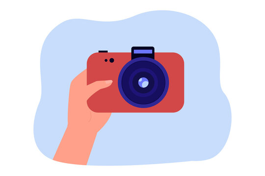 Hand of photographer holding red camera. Person buying camera or taking photo flat vector illustration. Photography, hobby, memories concept for banner, website design or landing web page