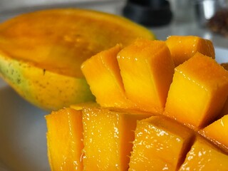 Close up of delicious ripe juicy mango fruit cut in cubes