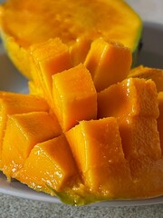 Vertical close up of delicious juicy mango cut in cubes