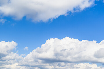 Naklejka na ściany i meble Blue sky background with white clouds. Beauty of nature