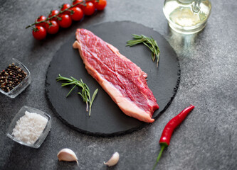 raw Picanha steak on stone background with spices