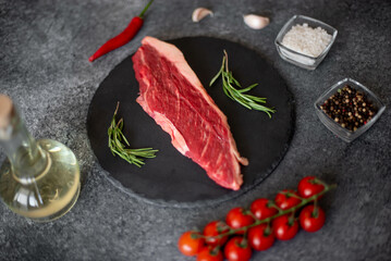 raw Picanha steak on stone background with spices