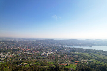 Aerial view over City of Zürich with bay of Lake Zürich on a beautiful spring day with blue cloudy sky background. Photo taken April 21st, 2022, Zurich, Switzerland.