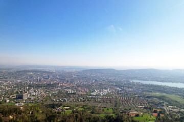 Aerial view over City of Zürich with bay of Lake Zürich on a beautiful spring day with blue cloudy sky background. Photo taken April 21st, 2022, Zurich, Switzerland.