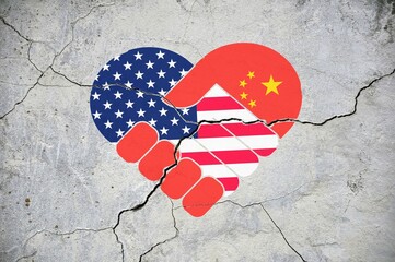 The symbol of close friendship cracks. Heart in colors of national flags of China and USA.
