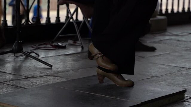 Feet of flamenco dancer stomping in slow motion. Silhouette shot