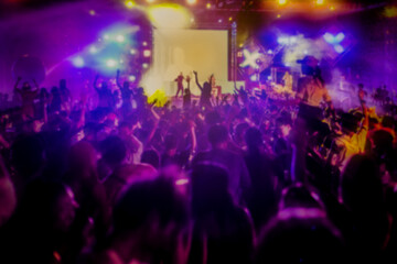 De-focused or blurred concert crowd enjoying the music.