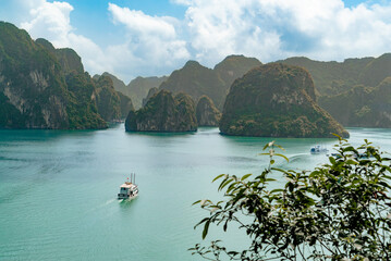 Boat cruising through the ocean sea mountains in ha long bay Vietnam