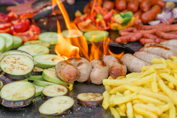 Fried vegetables with sausages and french fries