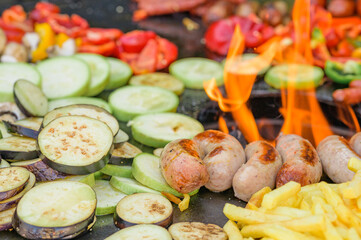 Fried vegetables with sausages and french fries