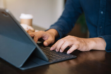 Businessman are using tablet to work at the desk in the morning.