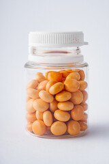 orange valerian pills on a white acrylic background
