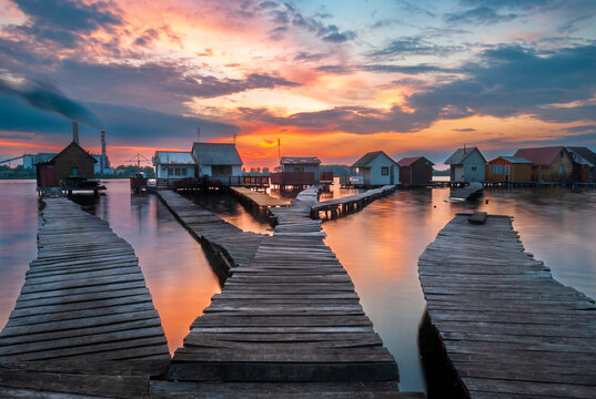 Small fishing cottages in the sunset on Bokod lake in Hungary