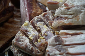 Almaty, Kazakhstan - 03.25.2022 : Smoked meat products are laid out for sale in an open market