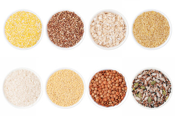 Set of different cereals: rice, buckwheat, corn, millet, bulgur, oatmeal in bowls on a white background
