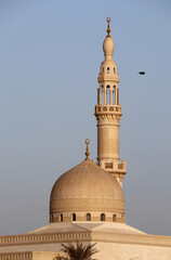 Minaret and dome of the mosque in Dubai at sunset