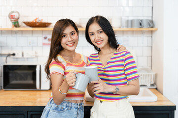lgbtq, LGBT concept, homosexuality, portrait of two Asian women posing happy together and showing love for each other while having coffee at the dining table