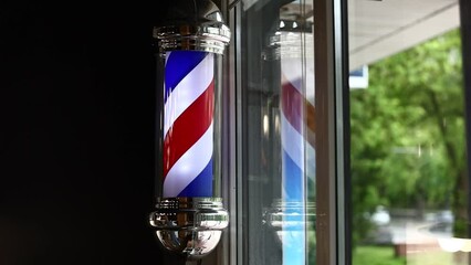 Barber shop vintage pole. copyspace Barbershop. Barber shop pole in red white and blue with lightbulb on top