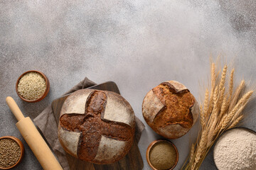 Wholegrain and hemp bread on gray background. View from above with copy space.