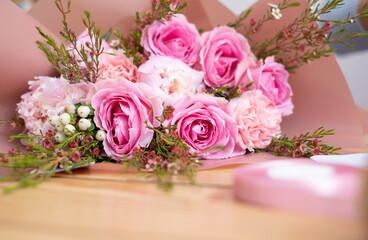 bouquet of pink and white flowers on a wooden table