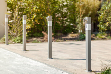 Bollards at concrete pavement. Traffic Gate with padlock. Bollards on footpath Entrance to Private Territory.