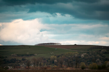 Fototapeta na wymiar Spring landscape with large clouds. Before the rain. Rural landscape.
